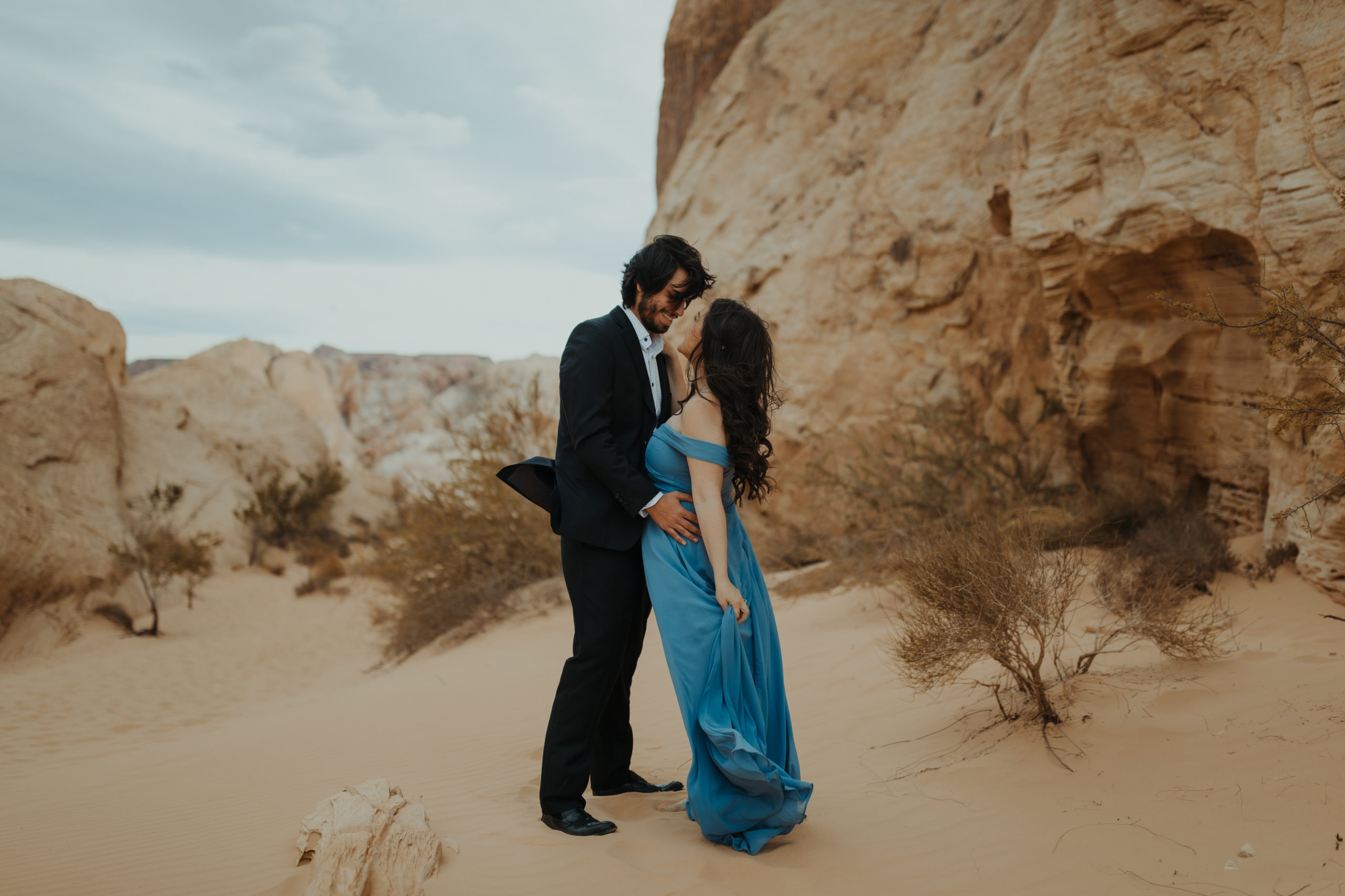 Close up of couple in desert in formal attire