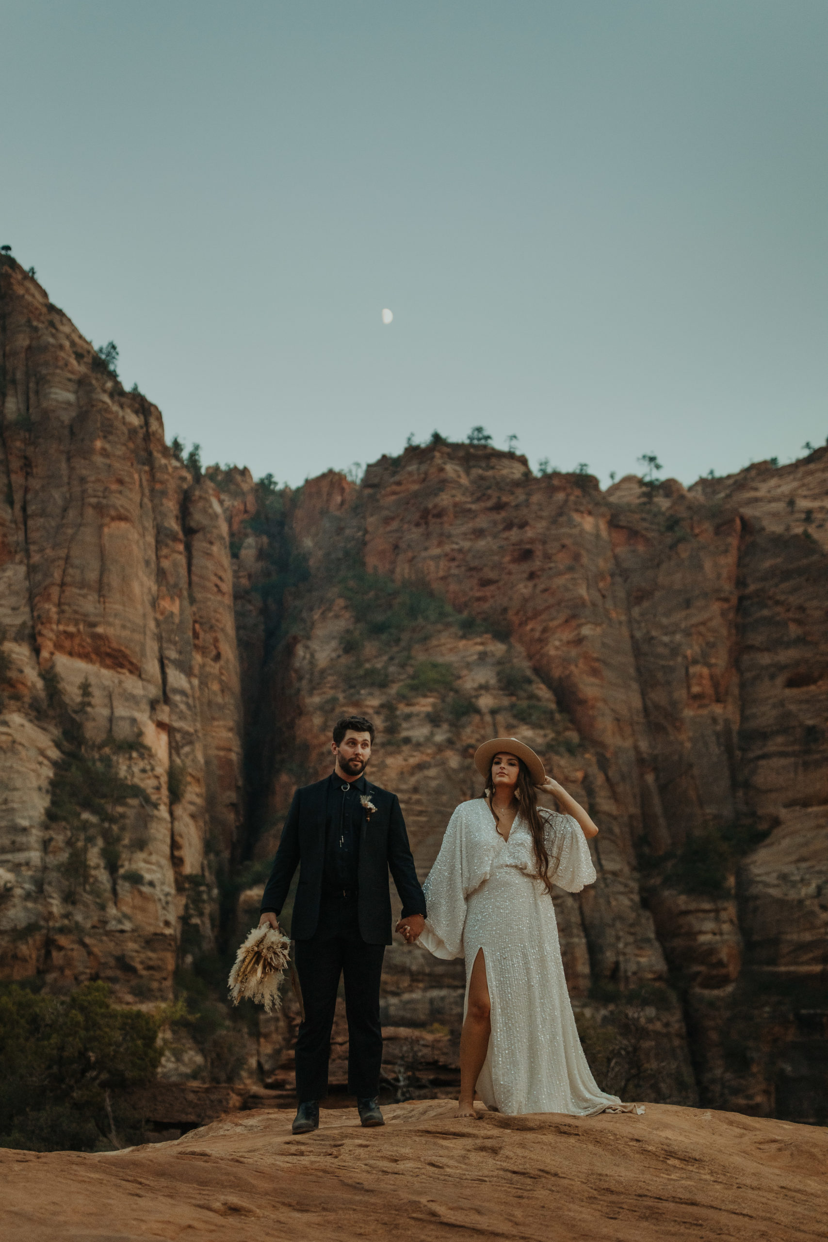 Boho elopement couple standing next to each other in their wedding attire
