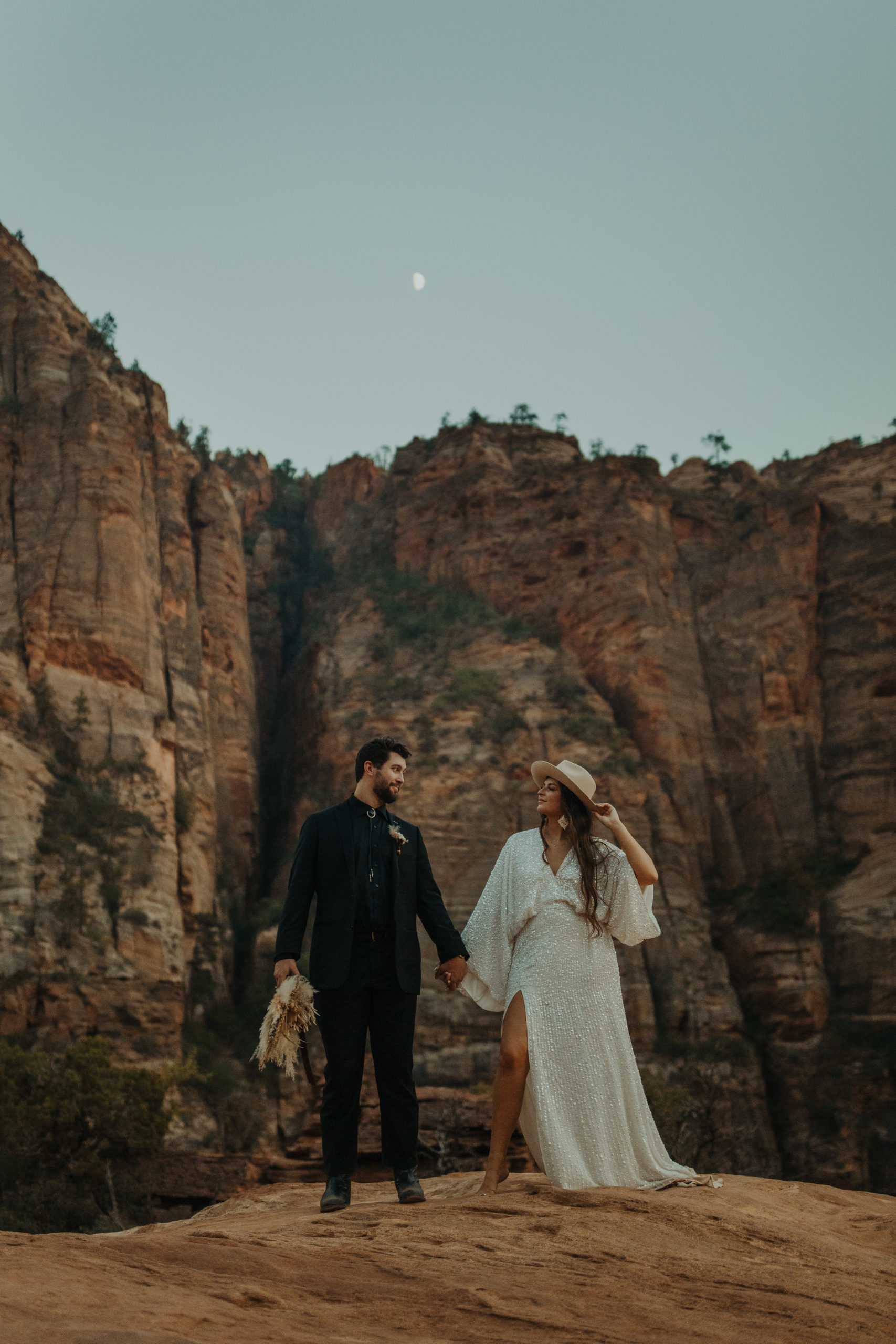 Boho elopement couple standing next to each other in their wedding attire