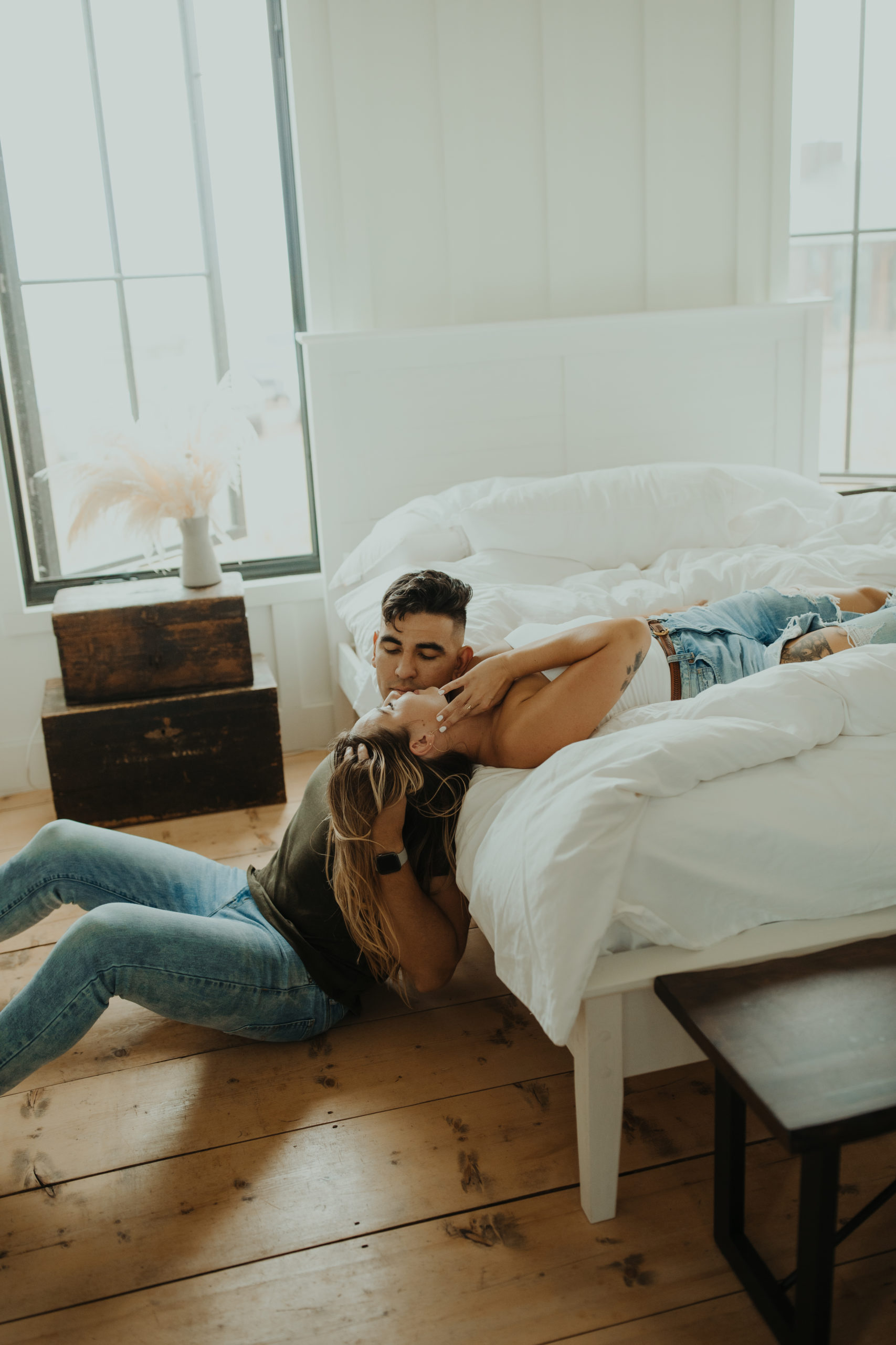 couple wearing grunge couple aesthetics outfits cuddled together on bed for an in home Colorado photo session