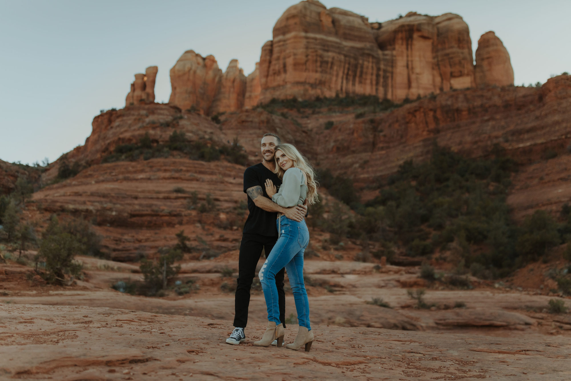 Casual Couple standing together in front of Cathedral Rock in Sedona, Arizona