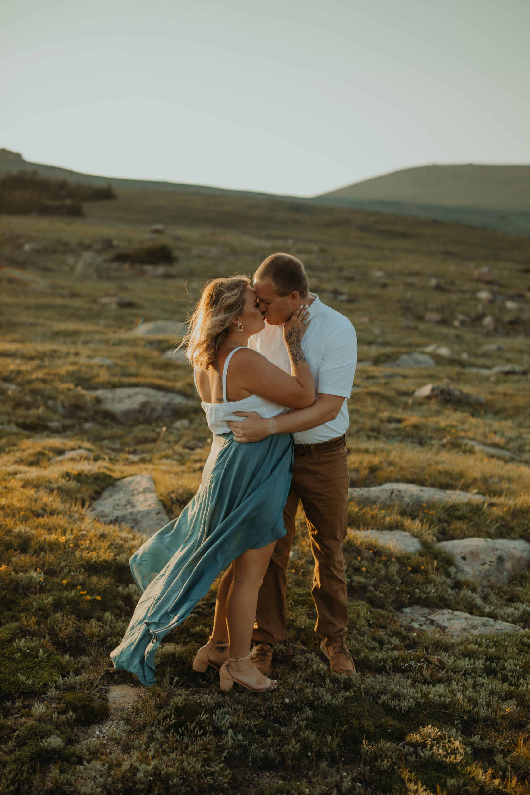 Couple kissing during golden hour photos in the Rocky Mountain National Park