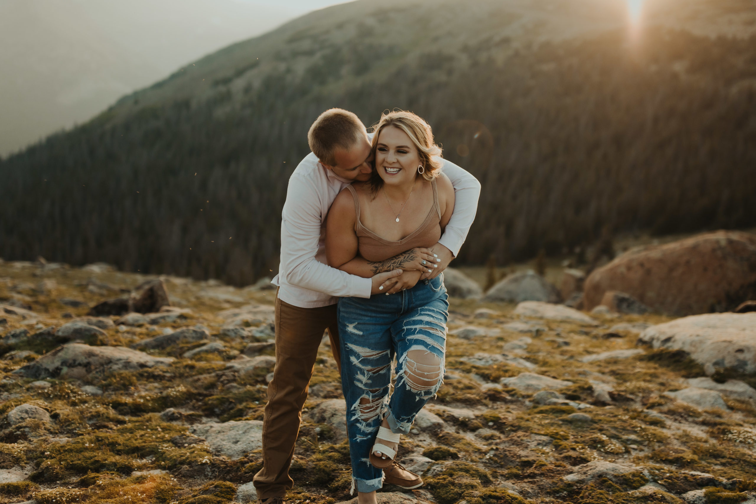 fun couple cuddling and running around the Rocky Mountain National Park