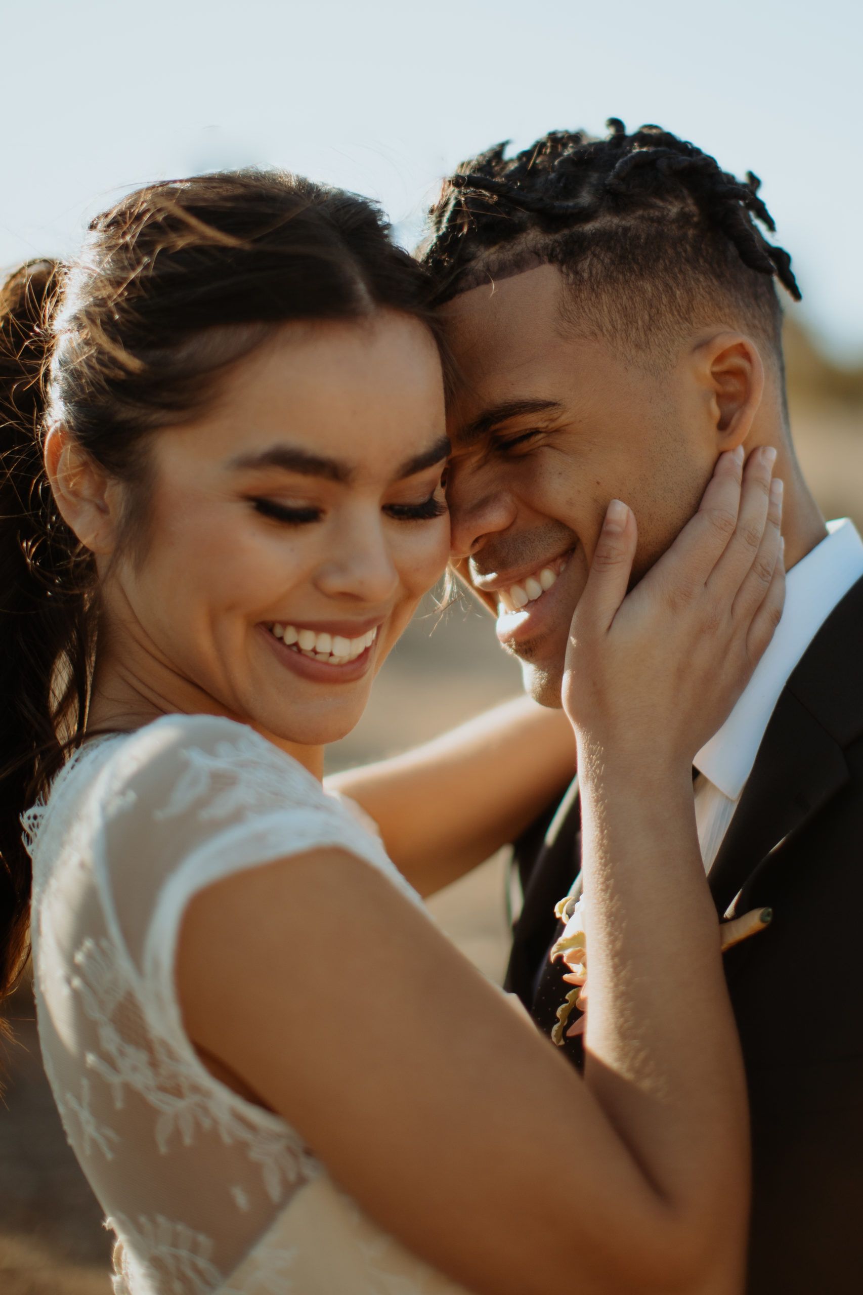 close up of laughing bride and groom