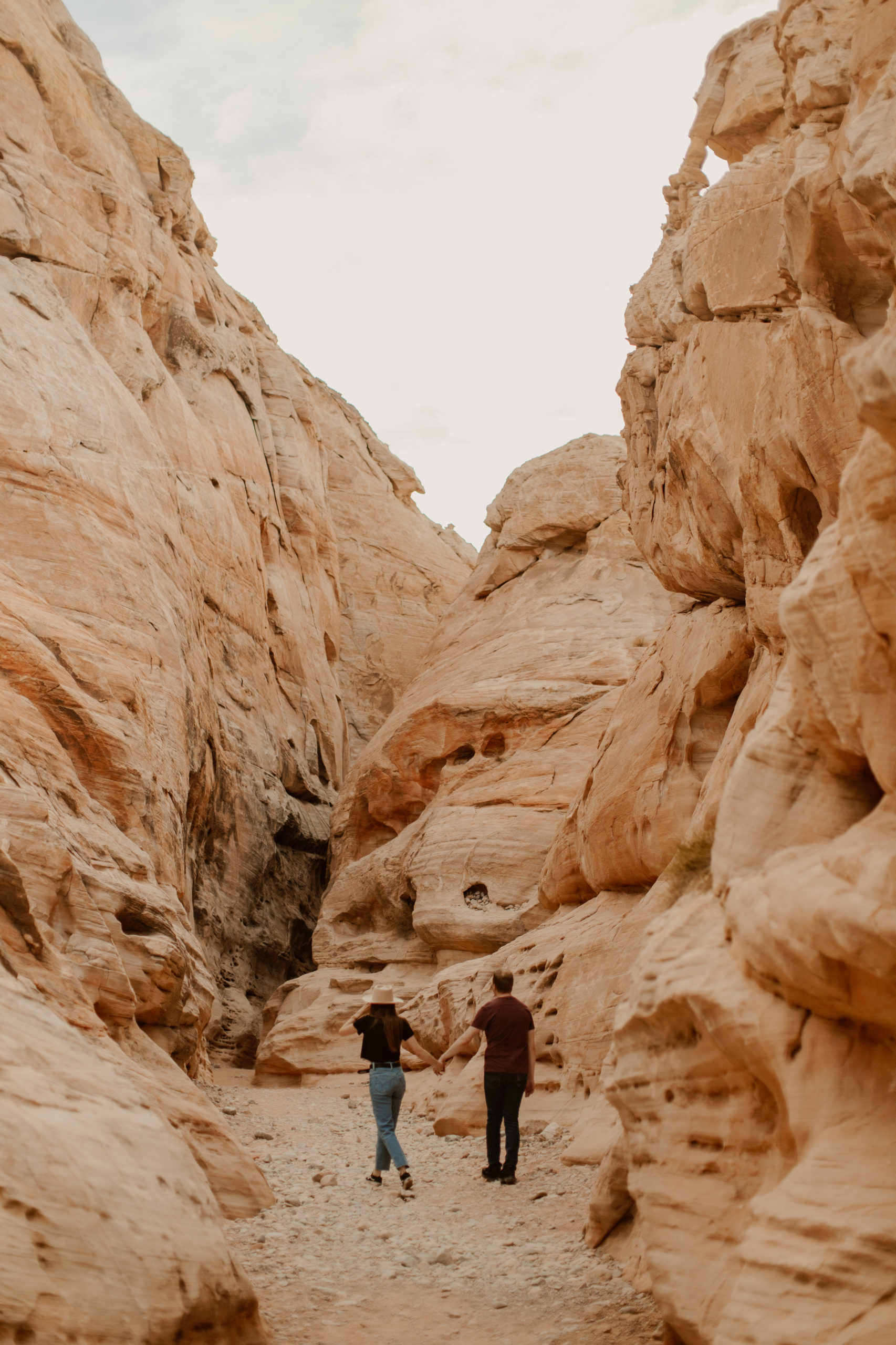 boho couple exploring slot canyons in Valley of fire
