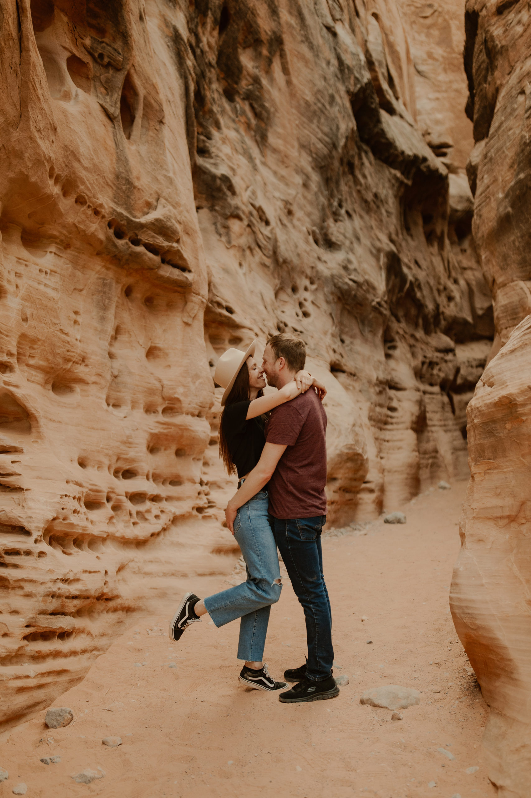Couple wrapped in each others arms in a slot canyon in valley of fire