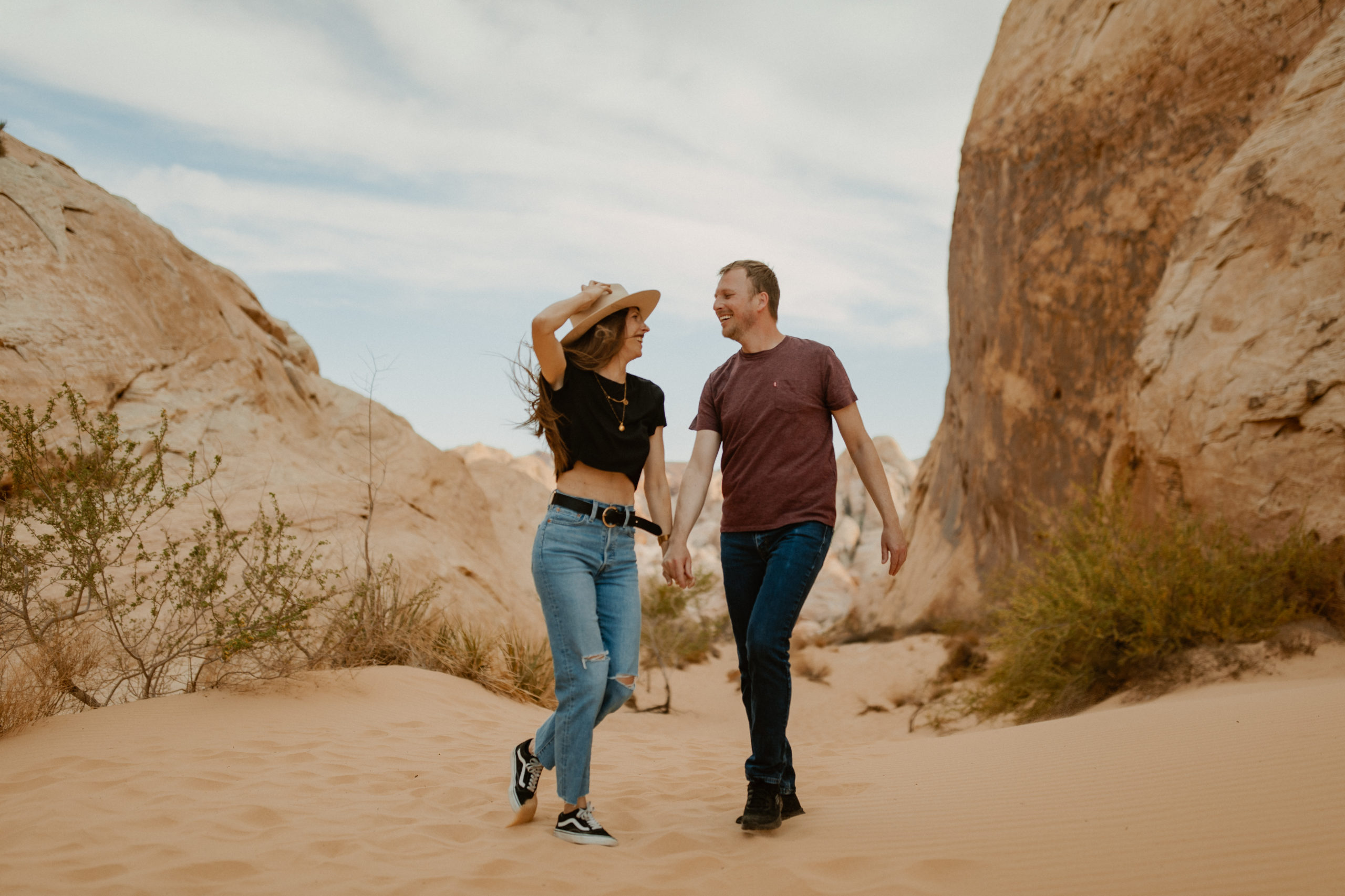 couple walking through valley of fire desert