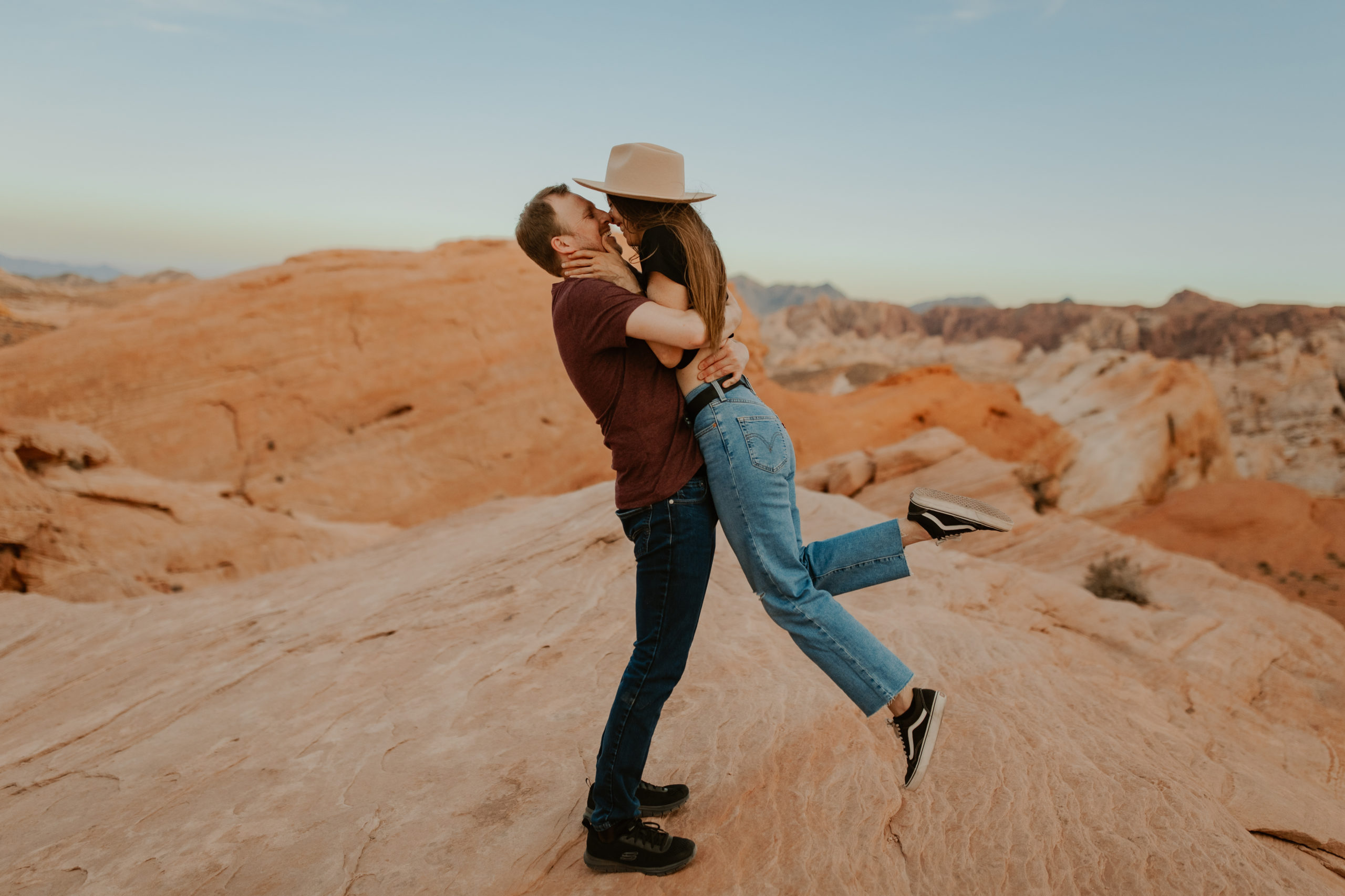 Fiance lifting girl up and giving her a kiss during engagement session