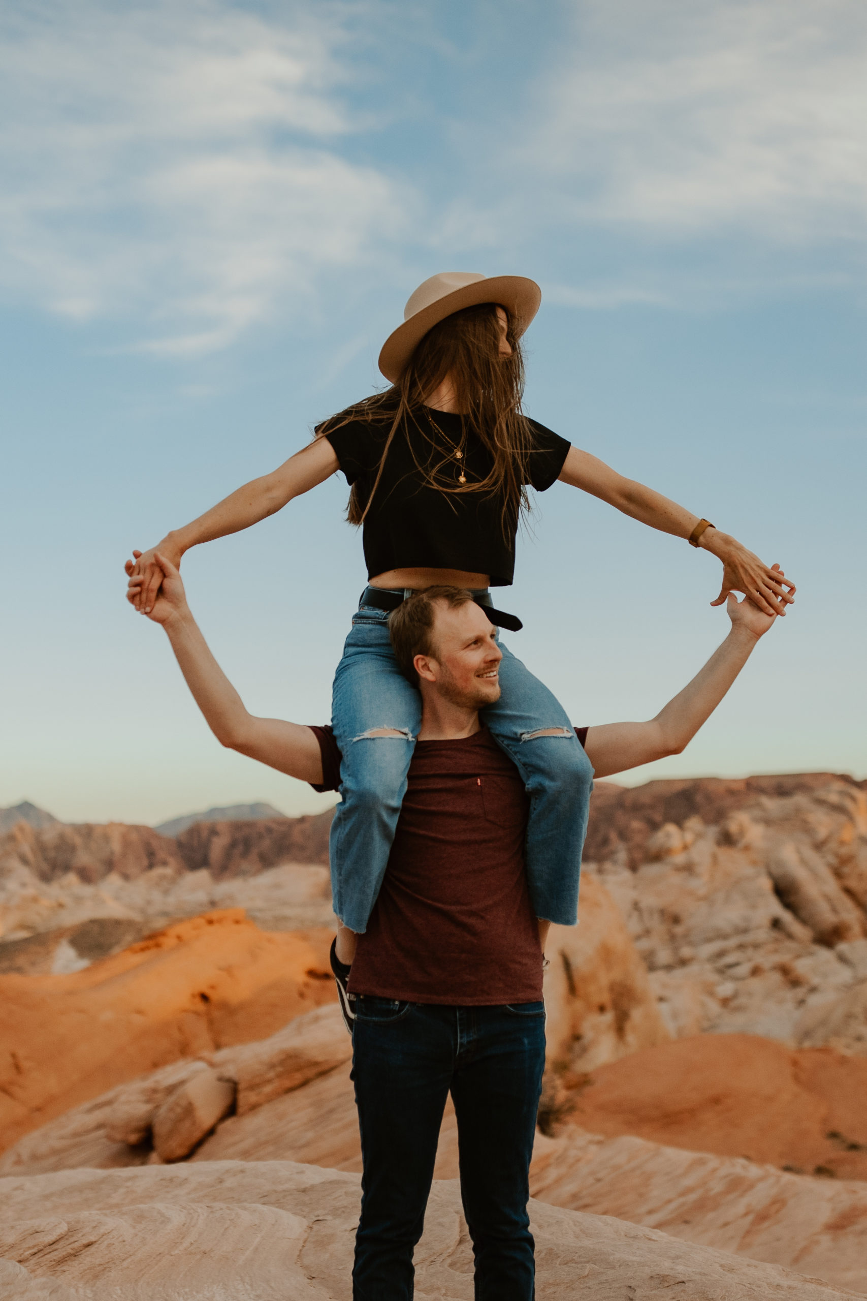 Girl on guys shoulder during engagement session in the valley of fire