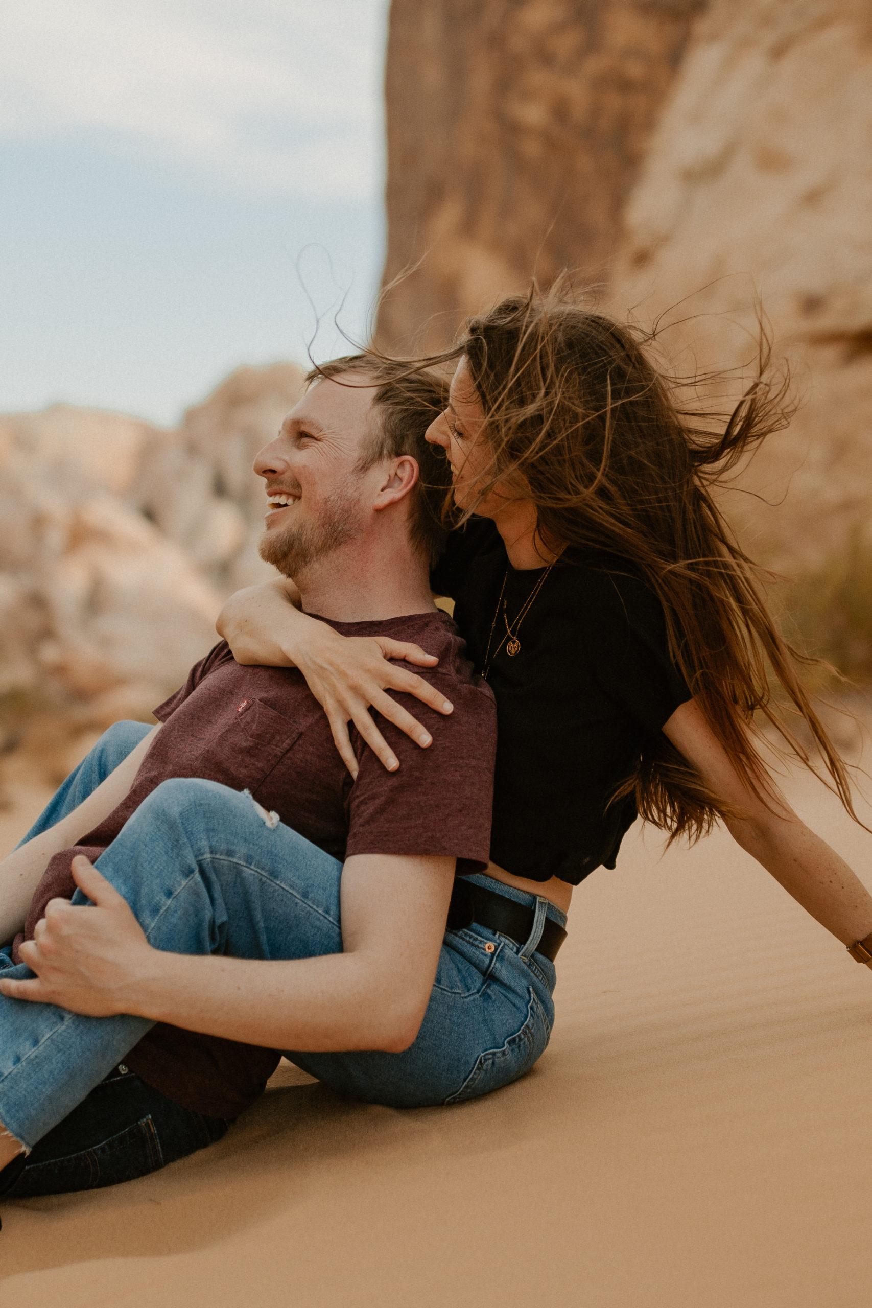couple sitting together in the sand in valley of fire