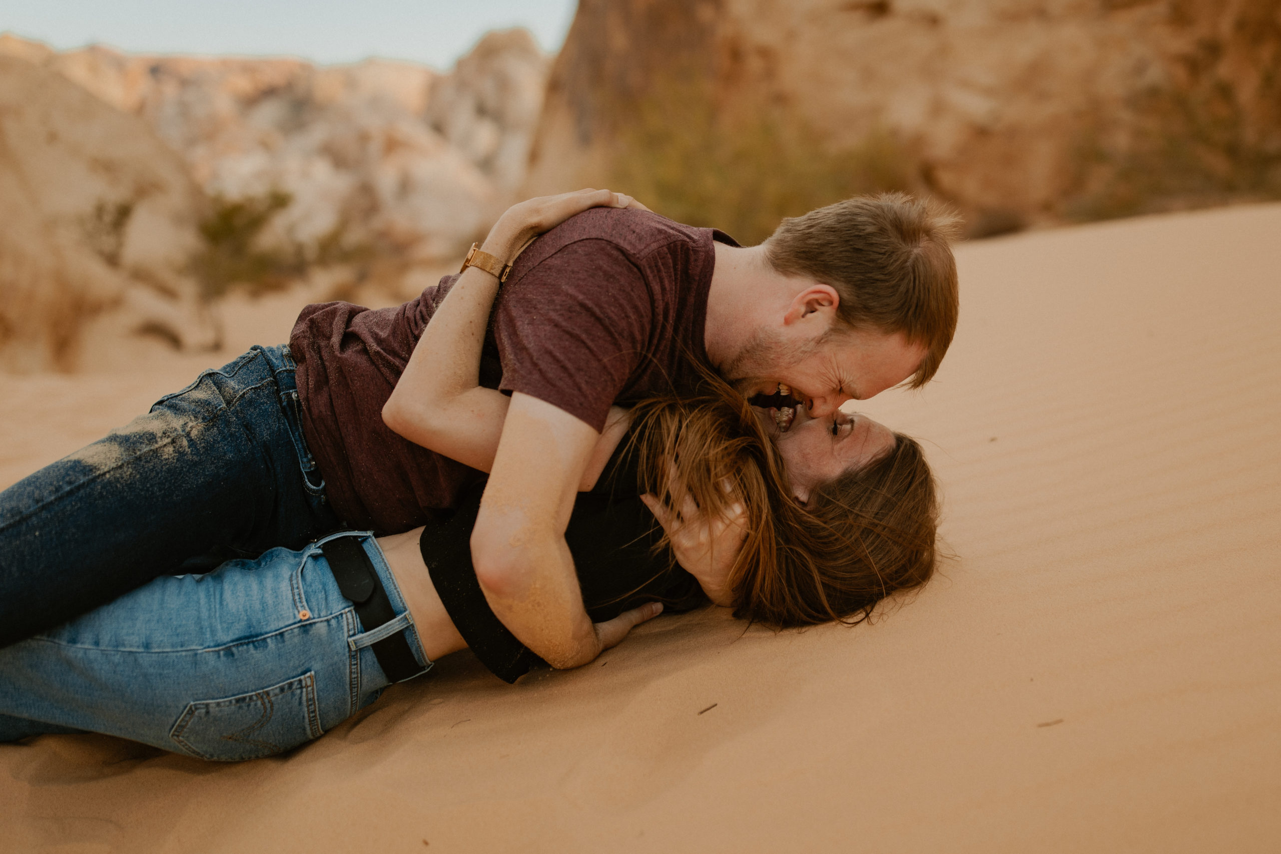 Man holding woman while kissing in the valley of fire