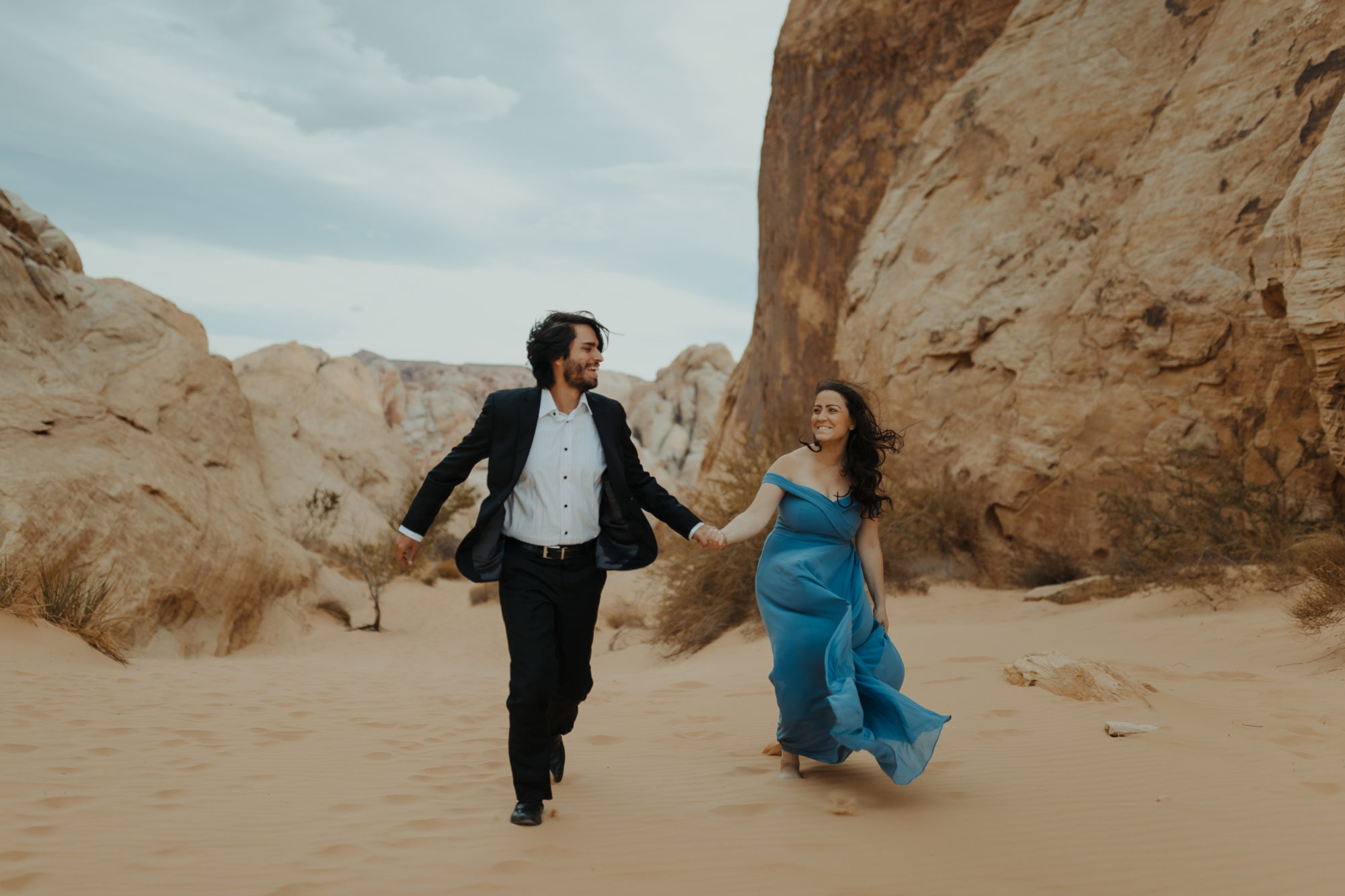 Close up of couple in desert in formal attire
