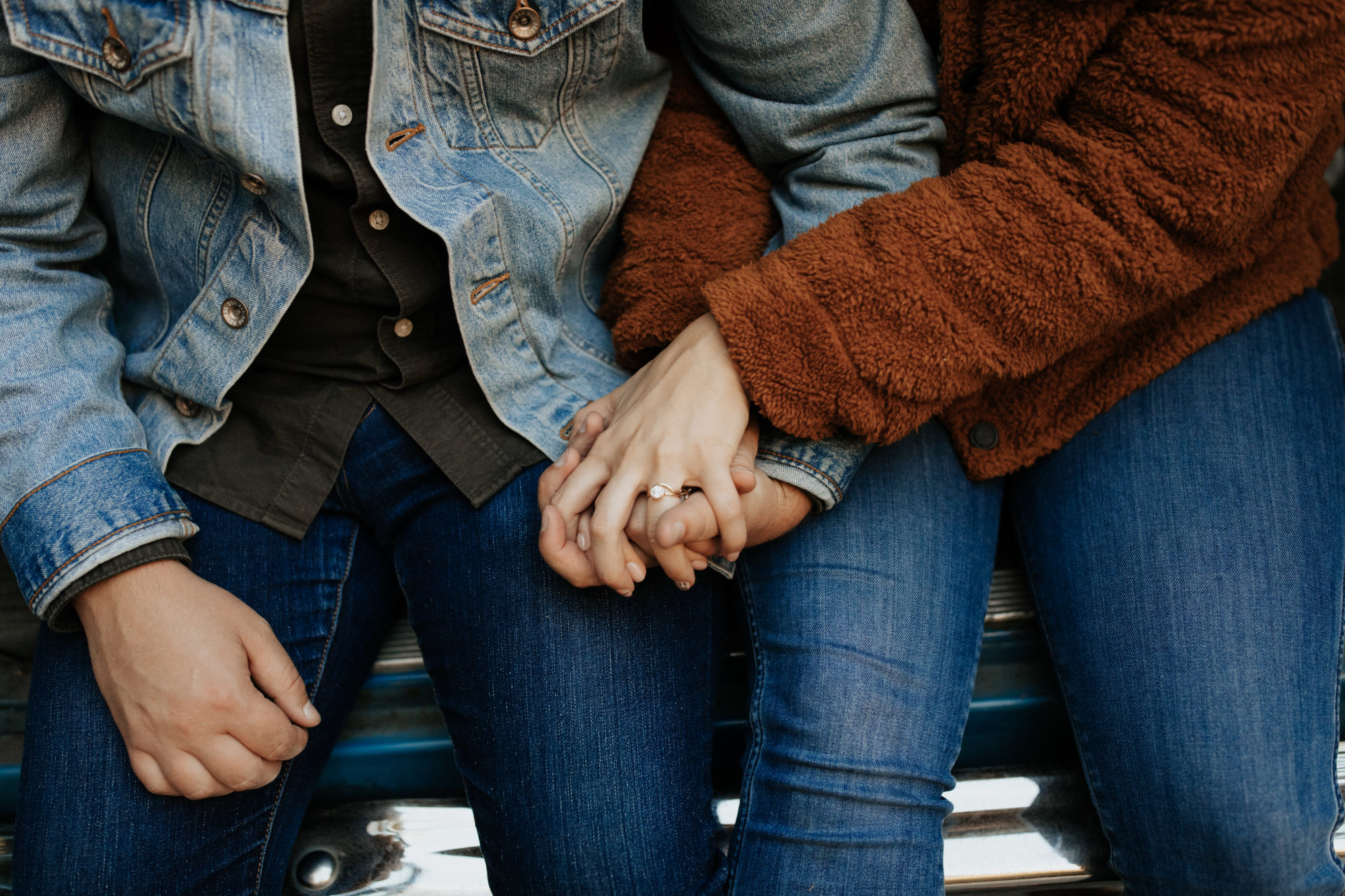 Engagement ring photo while couples holding hands