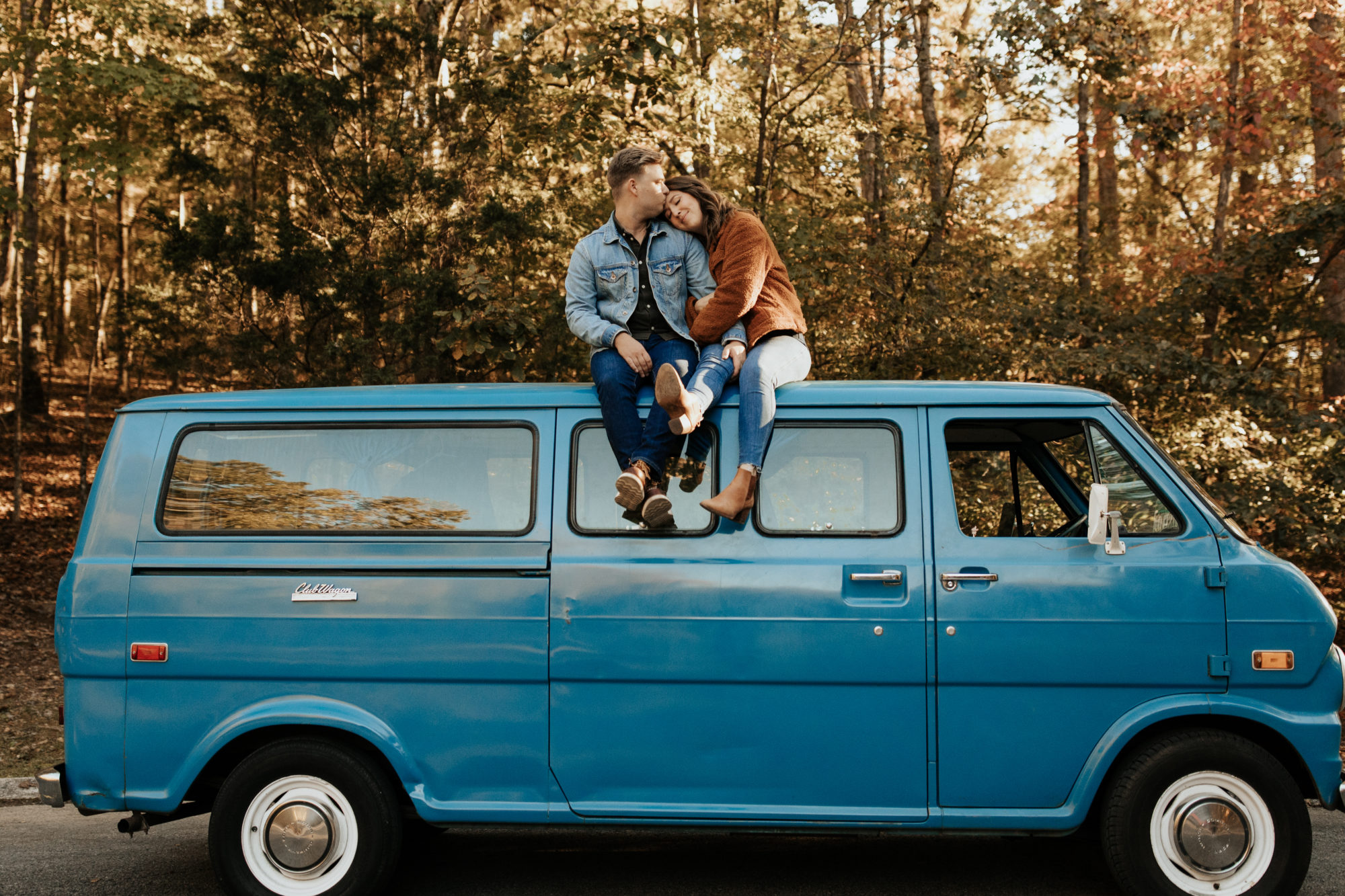 boho couple sitting on top of their campervan during their van life couples session