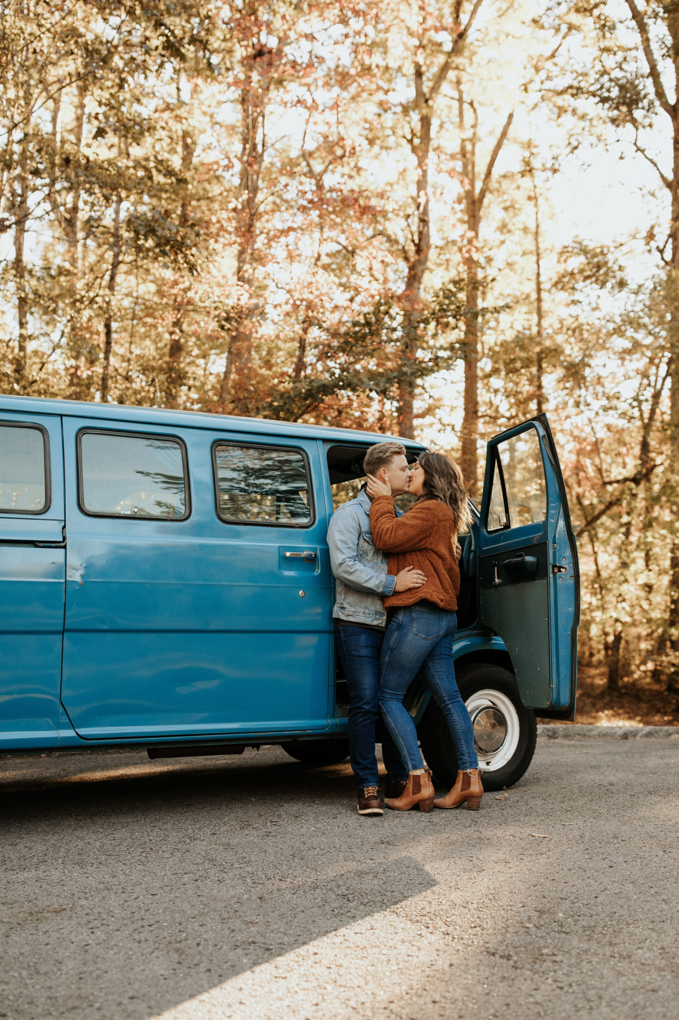 Cute couple kissing in front of their van life camper