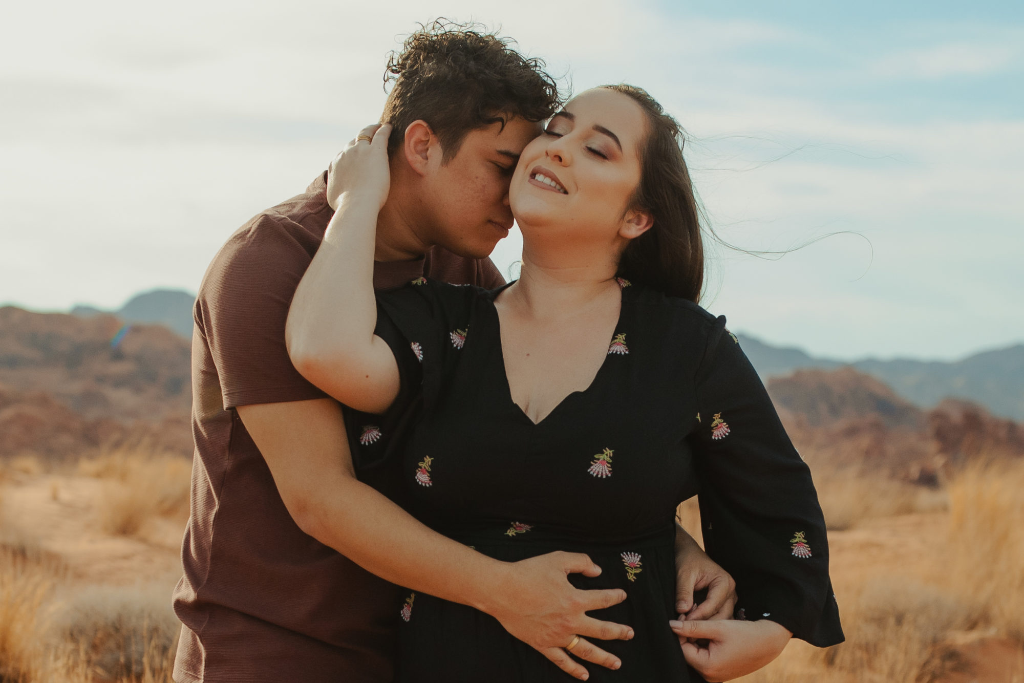 Couple sharing an intimate moment with their heads together in the desert