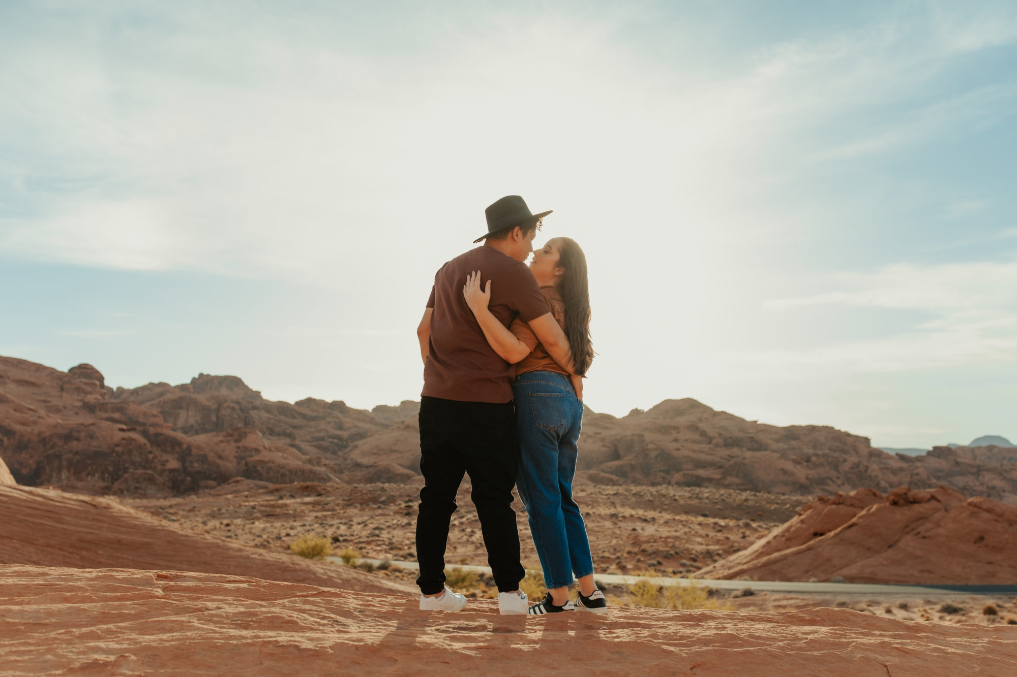 Sweet couple looking out into the sunset in the desert