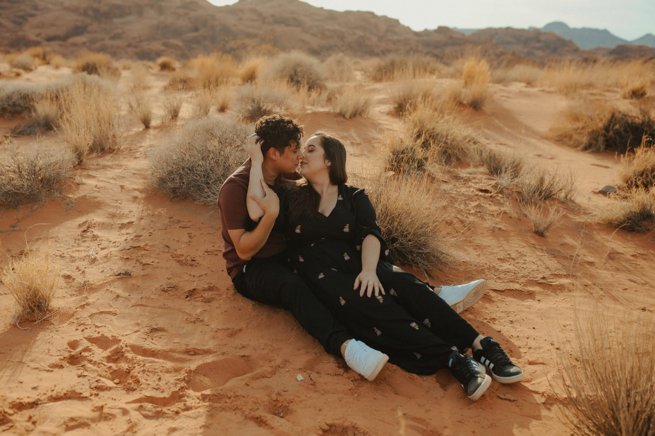 Couple sitting together on the ground in the desert