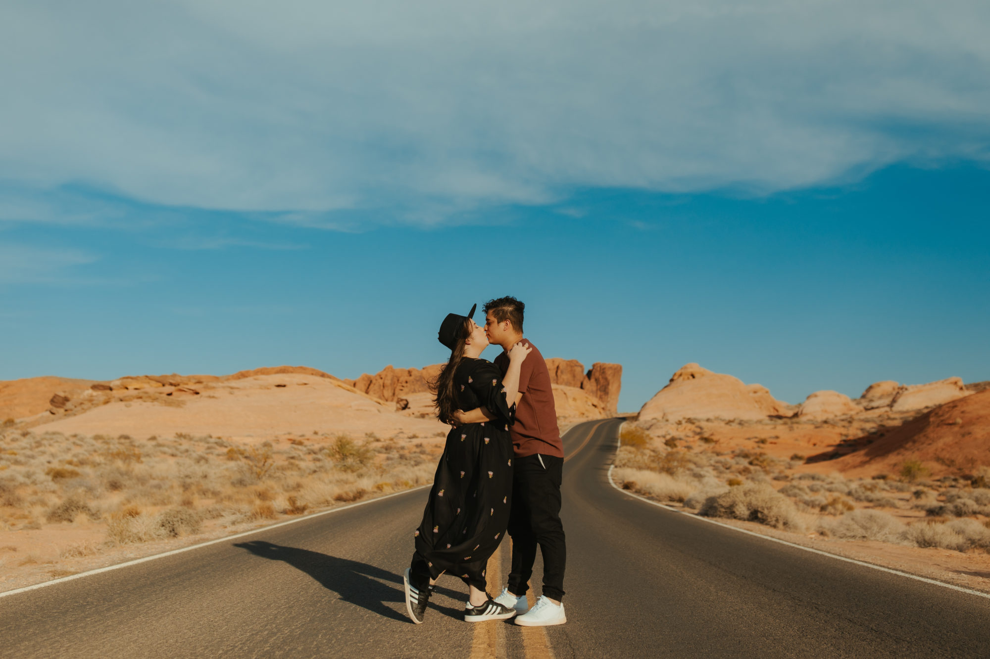Couple walking down a dirt road in the valley of fire