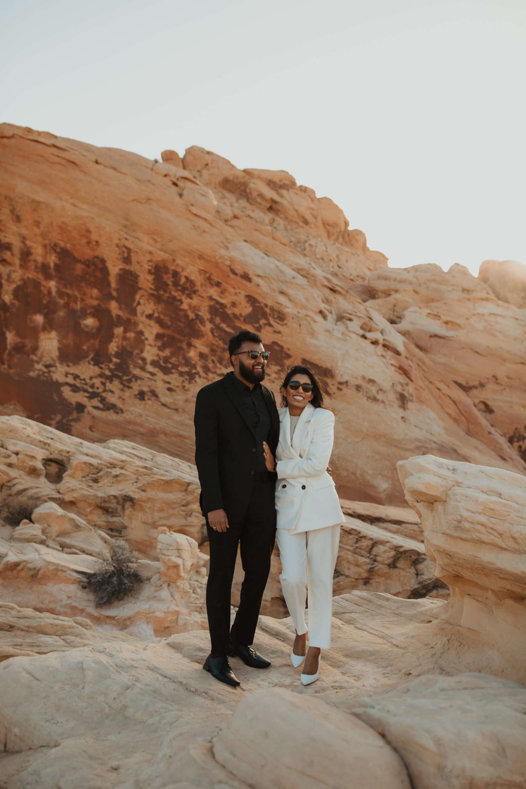 Couple smiling wearing sunglasses in the desert of valley of fire