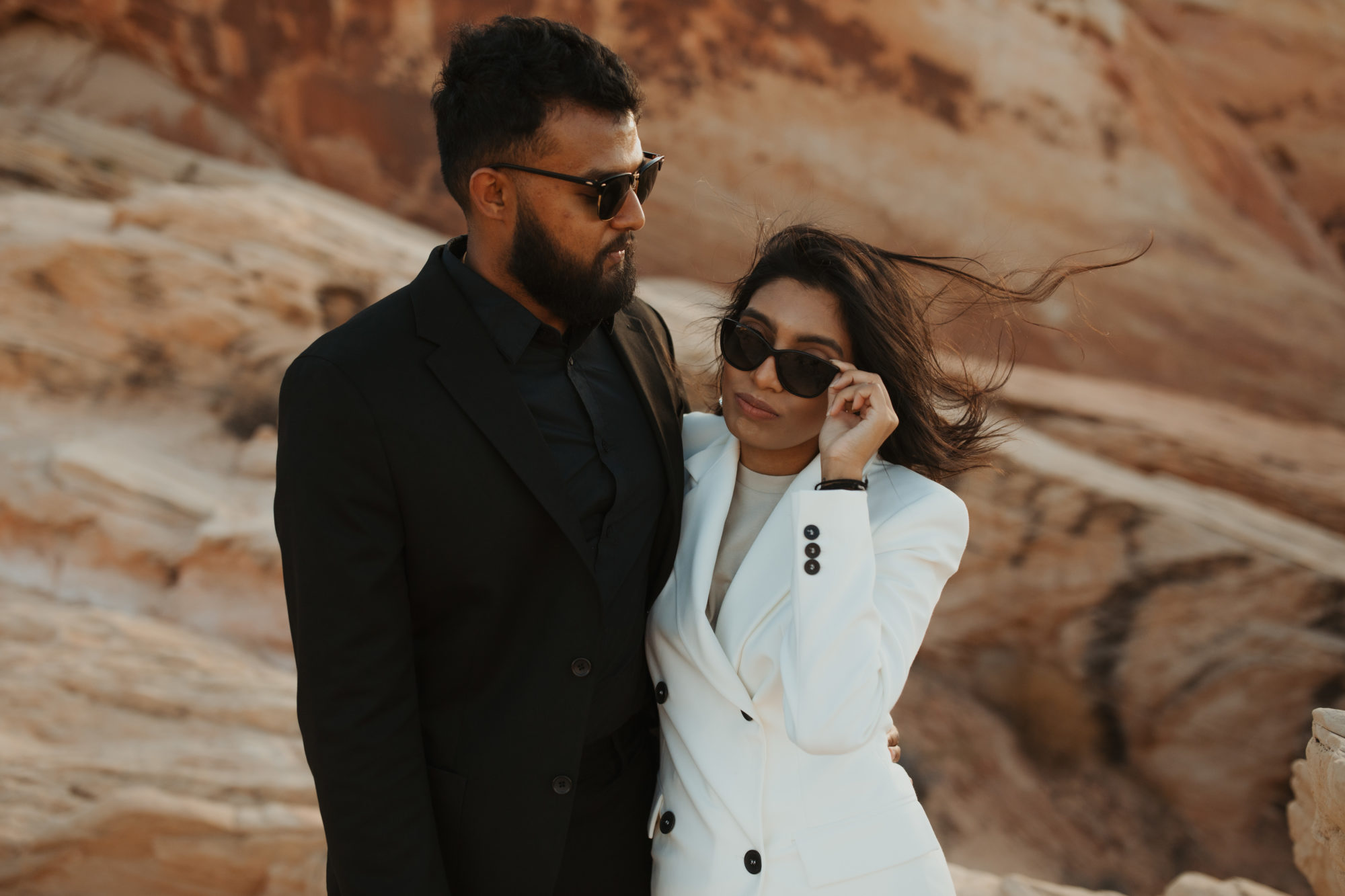 couple exploring desert with cool sunglasses on