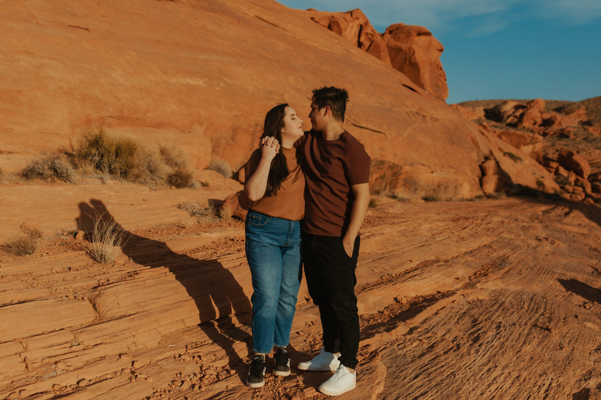 Couple cuddled up in the desert