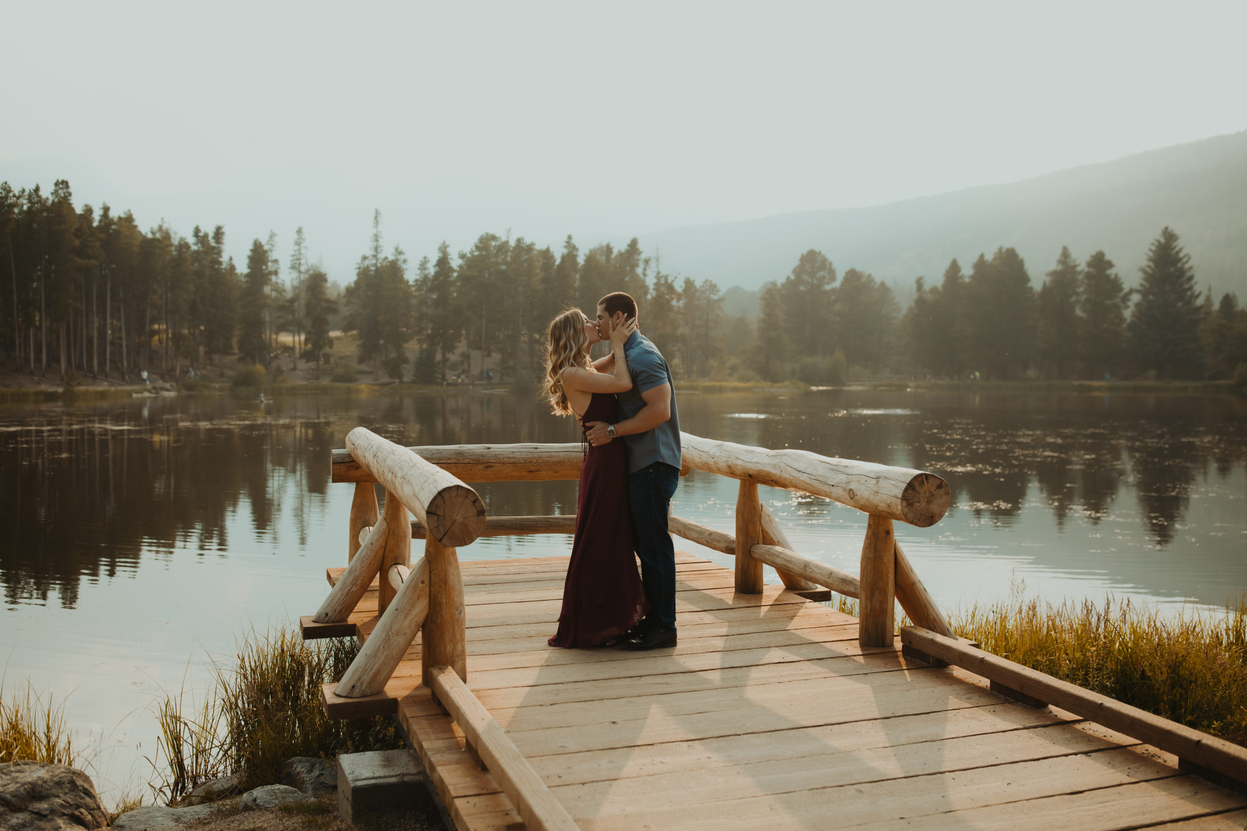 Couple kissing on a dock over a lake in the PNW