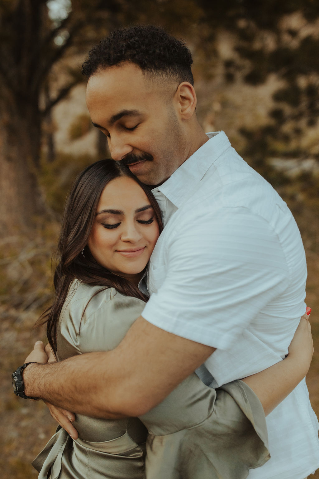 upclose portrait of couple hugging with their eyes closed