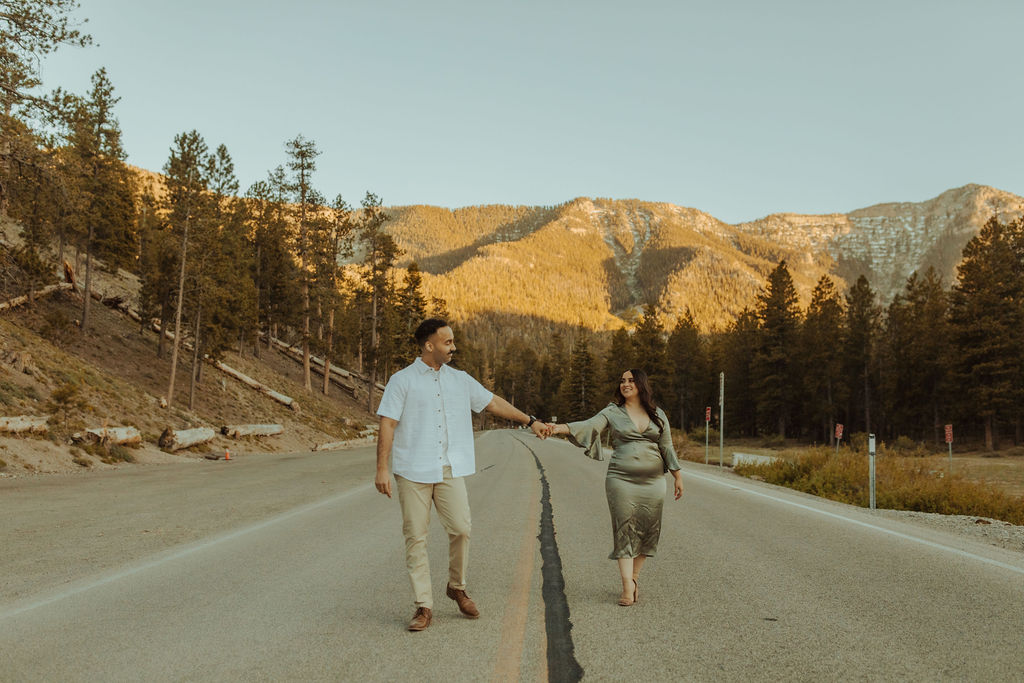 Couple holding hands walking down the road in mt. charleston nevada