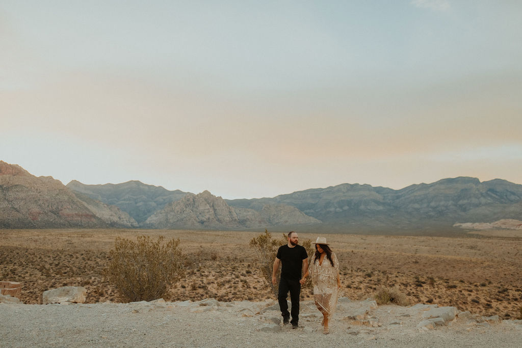 husband and wife walking through red rock canyon las vegas during their vow renewal