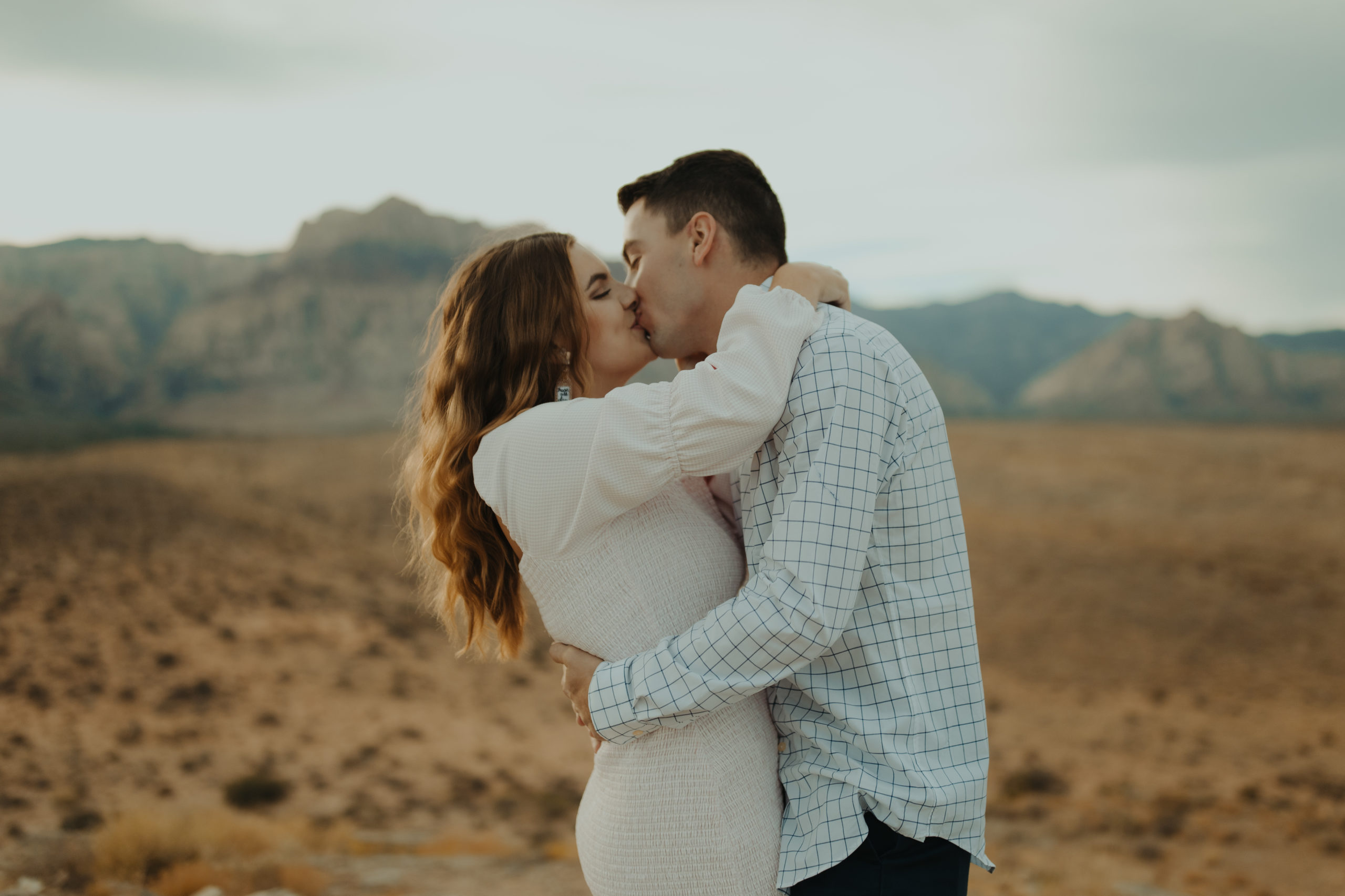 couple kissing in the desert