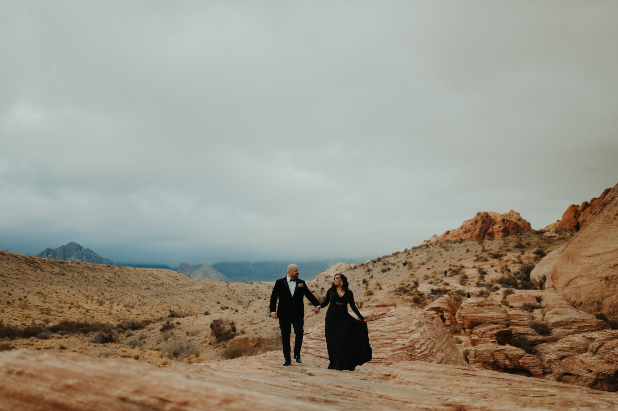 Couple posing for elopement photos in Red Rock Canyon for unique places to elope