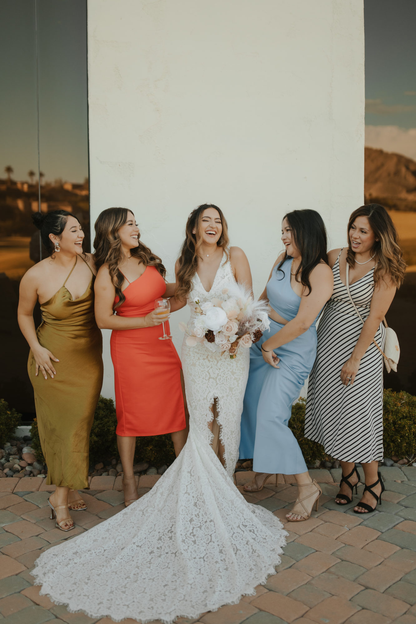 bride laughing with her girl friends after the wedding ceremony