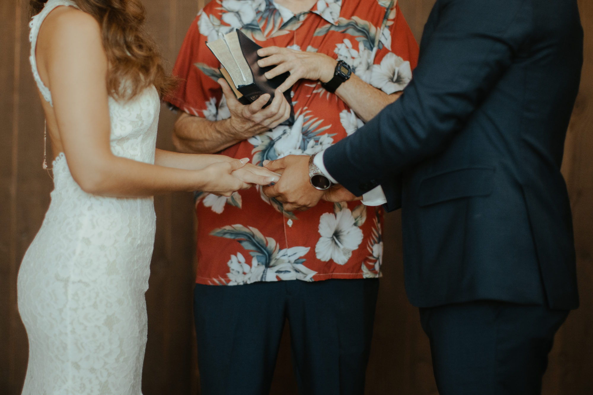 close-up of bride and groom holding hands during their wedding ceremony