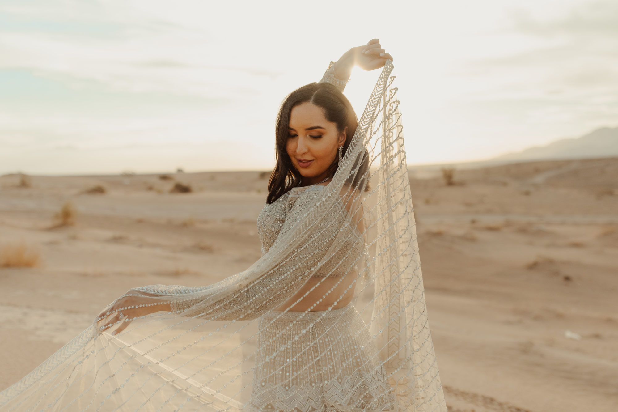 bride playing with her veil in the Nevada desert sand dunes