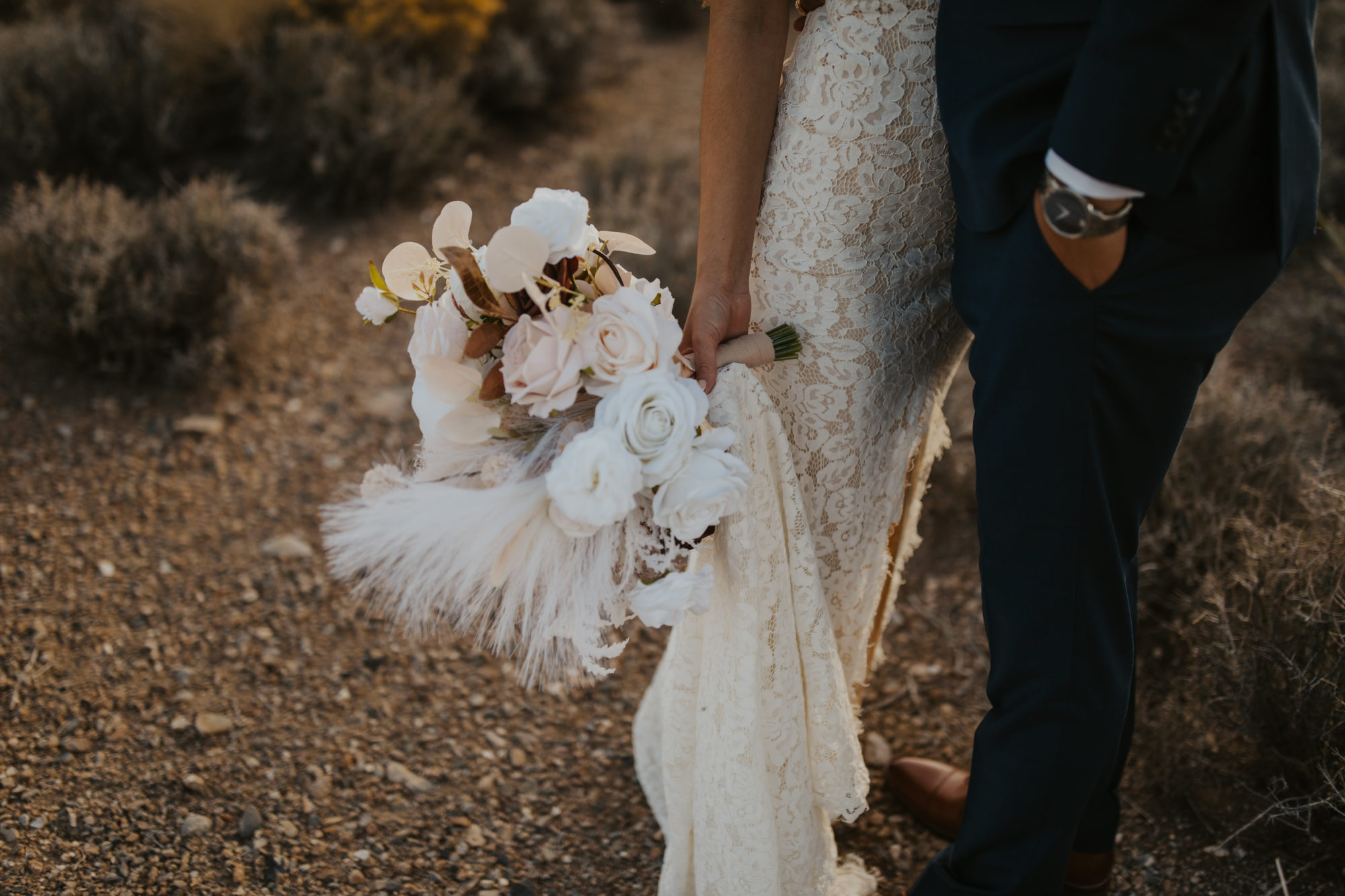 detail photo of bridal boquet and wedding dress during adventure photo session