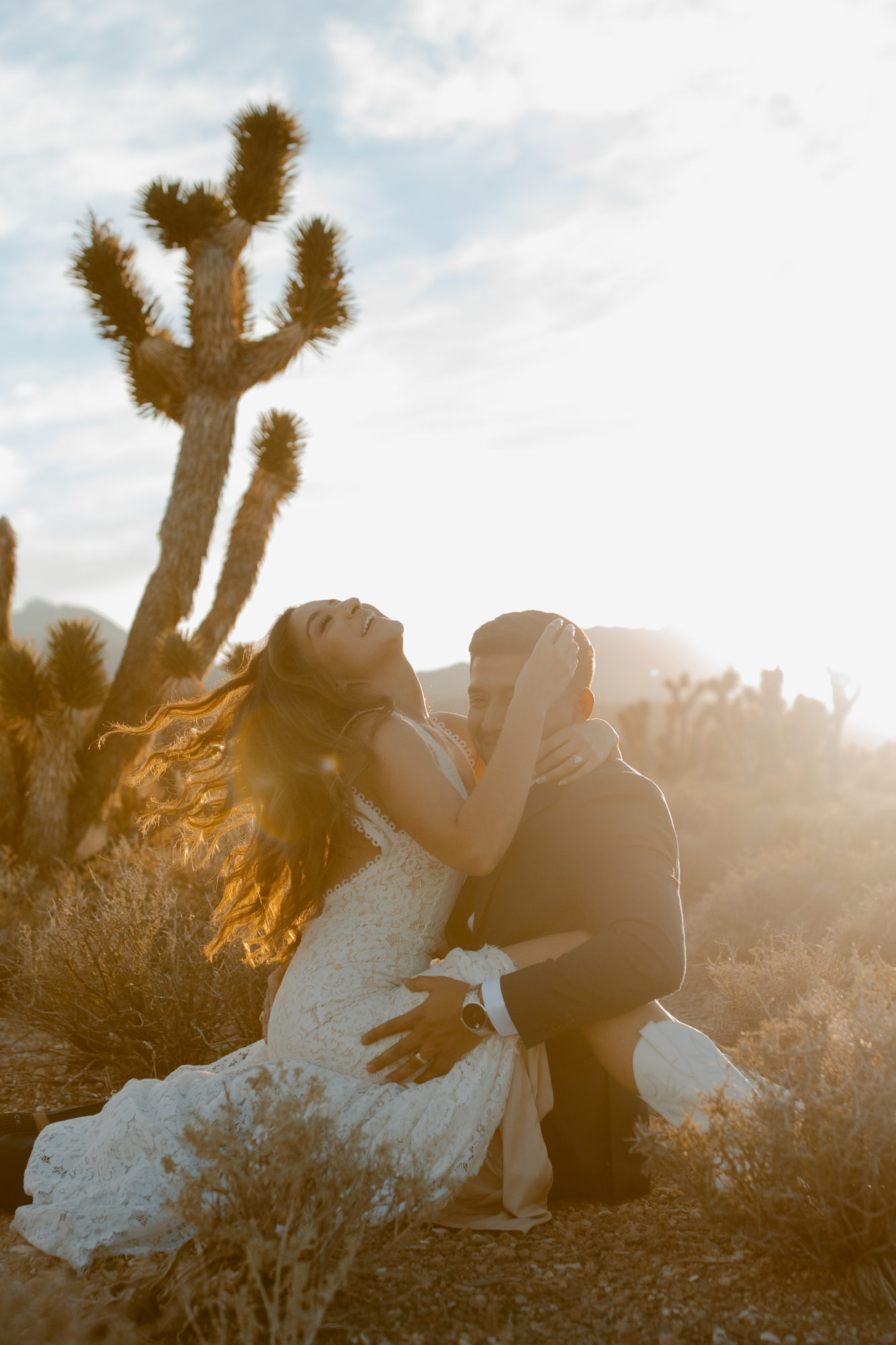 Bride sitting on grooms lap during adventure photo session