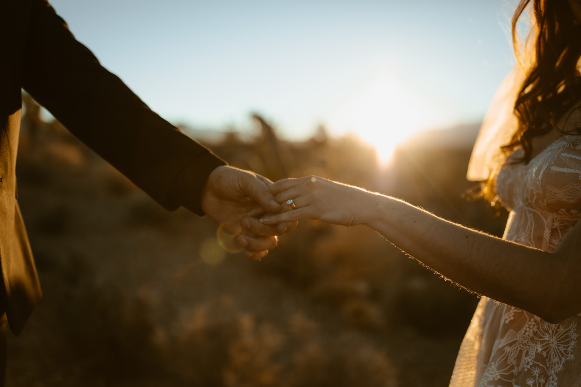 Bride and groom holding hands for portraits in the Mojave desert in Nevada